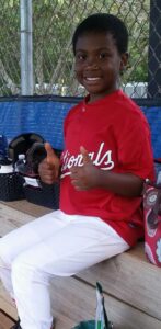 young child in baseball uniform