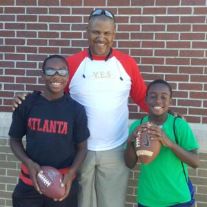 children and coach with football
