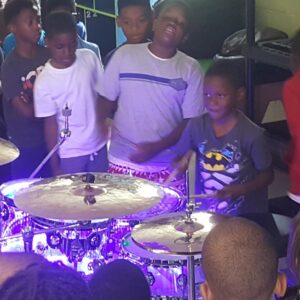 young person playing light up drums