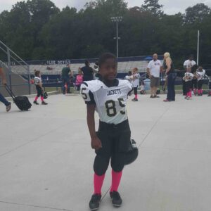 young boy in a football uniform