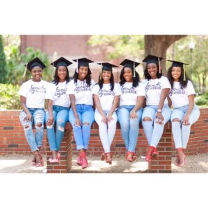 group of young female graduates in caps